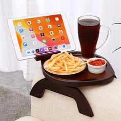 a tablet is sitting on a tray with french fries and ketchup