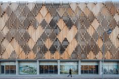 a large building with wooden slats on the front and side of it's facade