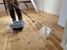 a person with a mop and bucket on the floor