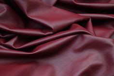 a close up view of a red leather textured material that looks like it has been dyed