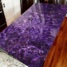 a purple marble counter top in a kitchen