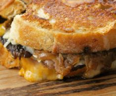 a grilled cheese sandwich on a wooden cutting board