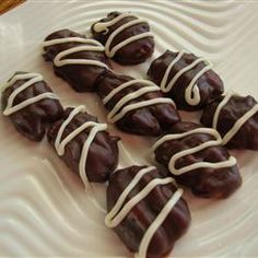 chocolate covered donuts with white icing on a plate