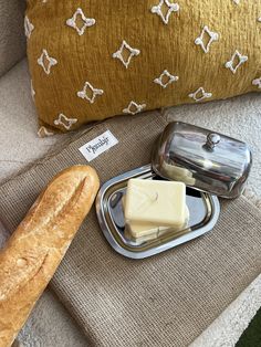 a loaf of bread sitting on top of a metal tray next to a loaf of butter