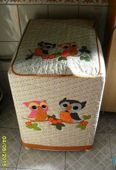 an owl themed quilted storage box in the kitchen