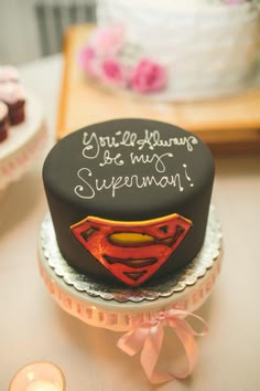 a birthday cake with a superman symbol on it