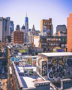 the city skyline is covered in graffiti and has many tall buildings with lots of windows