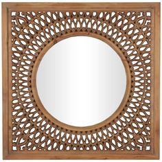 a wooden mirror with an intricate design on it