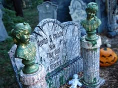 an old cemetery with statues and heads on it