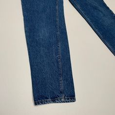 a pair of blue jeans laying on top of a white table