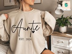 Custom Auntie Est Sweatshirt, Auntie Sweatshirt, Auntie Gift, Aunt Shirt, Christmas Gift Auntie, Mother's Day Sweatshirt, Mothers Day Gift -----How To Order----- 1-) Please, check and review all photos 2-) Choose your t-shirt size and color *Different styles of shirts may have different shades of same color choice due to different manufacturer brands. *For this reason, we recommend you to match shirts from the same styles if you want precisely matching colors (exa. Unisex, V-neck, Tank top, etc.). 3-) Click add to cart. You can go back to add more product 4-)Click "Proceed to check out" 5-)When you check out, you can add a note to seller for any request. ---------- Product ---------- * 4.2 oz., 100% airlume combed and ringspun cotton, 32 singles * 32 singles Athletic Heather and Black Heat Auntie Sweatshirt, Aunt Sweatshirt, Aunt Shirt, Auntie Shirts, Aunt Shirts, Auntie Gifts, Matching Colors, Color Choices, Different Styles