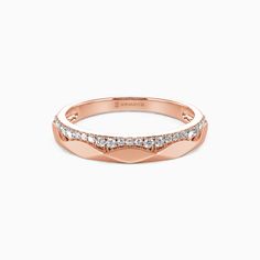 a rose gold wedding band with diamonds on the sides and a curved design in the middle