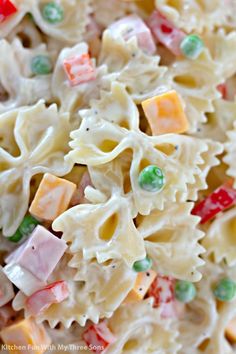 pasta salad with colorful candy candies and peas on top, ready to be eaten