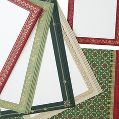 four different colored frames sitting next to each other on top of a white tablecloth