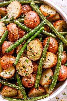 a white bowl filled with potatoes and green beans