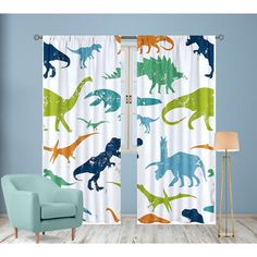 dinosaur curtains with different colors and sizes on them in a living room window sill