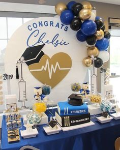 graduation decorations and balloons are on display at the celebration table in front of a sign that reads congratulations chelli