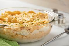 a bowl filled with mashed potatoes on top of a table