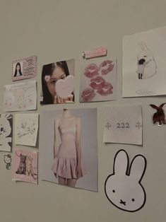 the wall is covered with many different pictures and drawings, including bunny ears on them