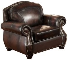 a brown leather chair with studded trimmings on the arms and footrests