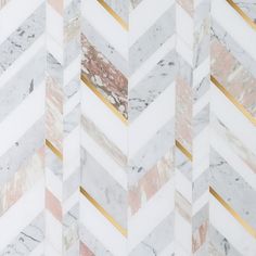 marble chevron wallpaper with gold and white stripes on it's edges in an angled pattern