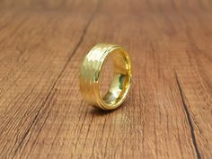 a gold ring sitting on top of a wooden table