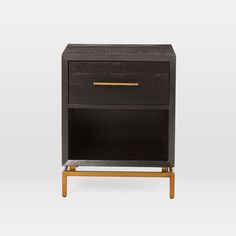 a black and gold nightstand with an open drawer on it's side stand, against a white background