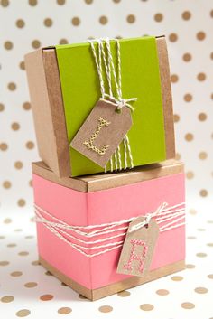 two small boxes with tags and twine on them