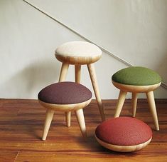 three stools sitting on top of a wooden floor next to a stair case in a room