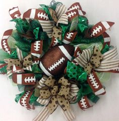 a football wreath with green and brown bows