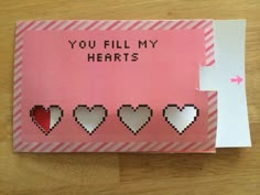 a pink card with hearts cut out of it