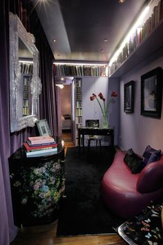 a living room filled with furniture and bookshelves