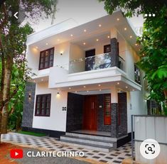 a white and black house with red doors