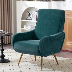 a green chair sitting on top of a rug in front of a book shelf filled with books