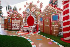 an indoor play area with gingerbread houses and candy canes on the walls, decorated for christmas