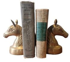 two books are sitting next to each other in front of a horse head bookend