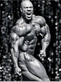 a bodybuilding man posing for the camera with his mouth wide open and muscles exposed