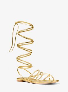 These barely-there lace-up sandals are a glamorous way to ground dresses and skirts. Crafted in Italy from metallic leather, they feature a flat leather sole for ease of wear. Gold Flat Heel Lace-up Sandals For Party, Chic Flat Lace-up Sandals For Party, Chic Metallic Sandals For Summer, Elegant Gold Leather Lace-up Sandals, Metallic Strappy Sandals For Spring, Spring Metallic Strappy Sandals, Luxury Strappy Lace-up Sandals For Summer, Gold Lace-up Sandals For Evening Summer Wear, Luxury Metallic Sandals For Spring