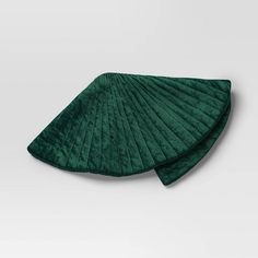 two green pleated napkins sitting on top of each other