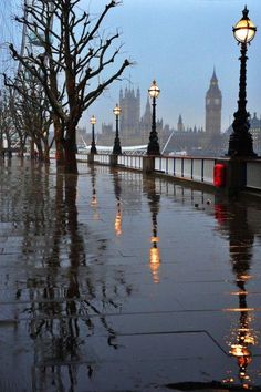 the big ben clock tower towering over the city of london on a rainy day in england