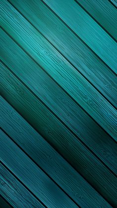 an image of wood planks that are very dark green and blue with some light on them