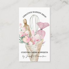 a bakery business card with pink flowers and whisks in a vase on a marble background