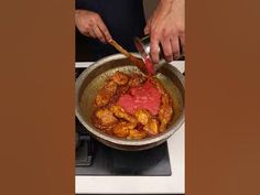 a person is cooking food in a pan on the stove