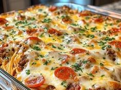 a casserole dish with meat, cheese and pepperoni on top is shown