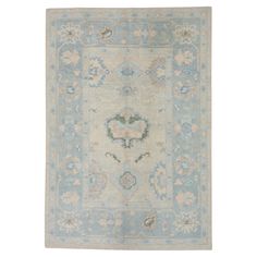 an antique rug with blue and beige colors