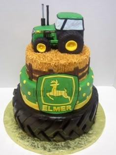 a cake made to look like a tractor with hay on the front and back wheels