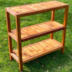 a wooden shelf sitting on top of a lush green field