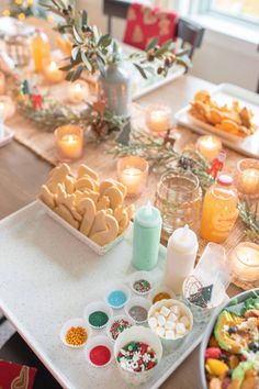 the table is set with cookies, candy and candies for christmas dinner guests to enjoy