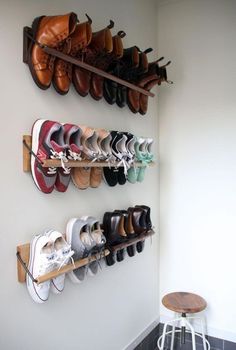 there are many pairs of shoes hanging on the wall