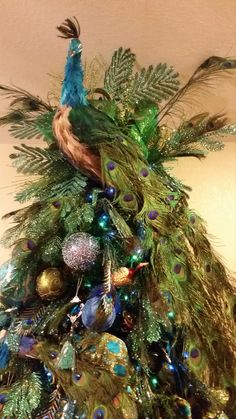 a peacock sitting on top of a christmas tree